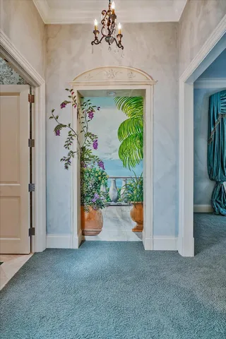 a living room with furniture a fireplace and a chandelier