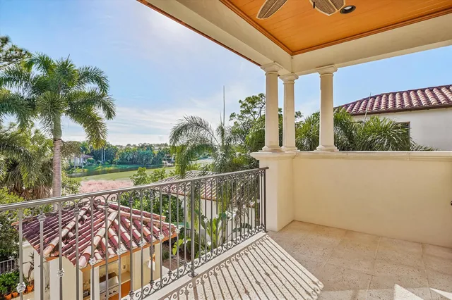 a bedroom with a large bed chandelier and a window