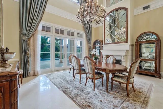 a view of a dining room with furniture and a chandelier