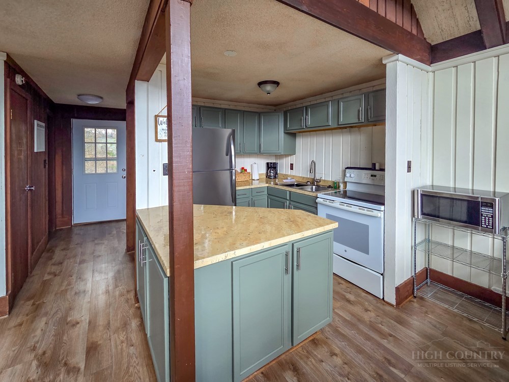 105 North Pinnacle Ridge Road, Unit 6 Beech Mountain, NC 28604 - Photo 11 of 46 a kitchen with stainless steel appliances granite countertop a refrigerator and a sink