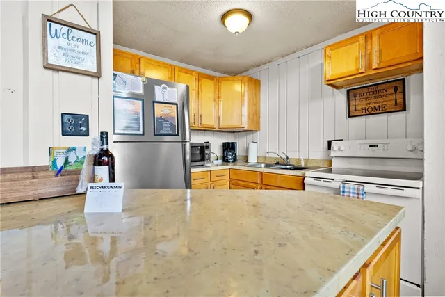 a kitchen with stainless steel appliances granite countertop a sink and cabinets