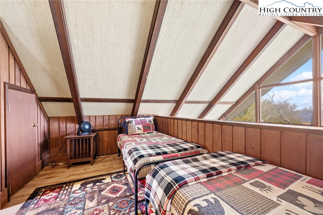 105 North Pinnacle Ridge Road, Unit 6 Beech Mountain, NC 28604 - Photo 17 of 46 a bedroom with a bed next to a large window