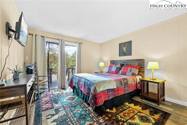 a bedroom with a bed table and a window