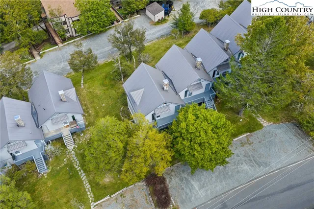 an aerial view of a house with a garden and yard