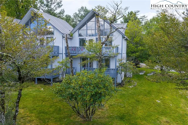 a aerial view of a house with a big yard plants and large trees