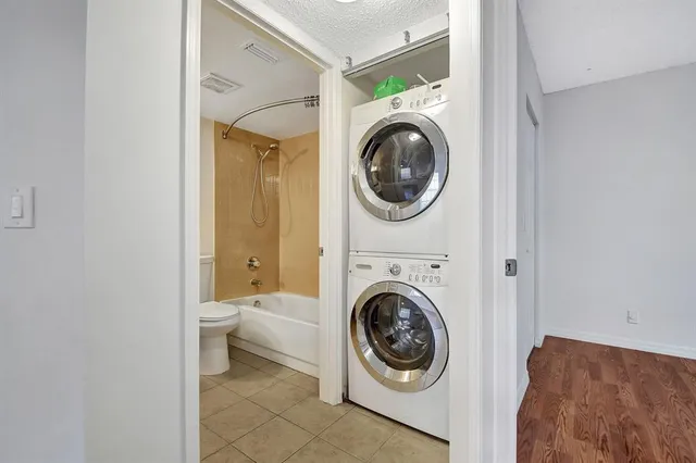 a view of a bedroom with washer and dryer