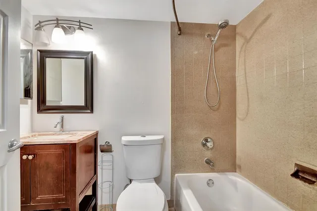 a bathroom with a toilet a sink and bathtub