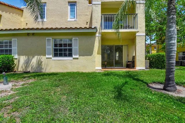 a view of a house with garden and plants