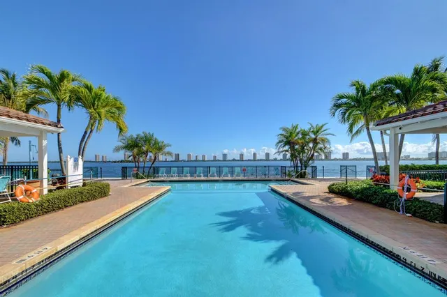 a swimming pool with outdoor seating and yard