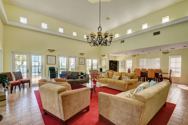 a living room with furniture or chandelier and a wooden floor