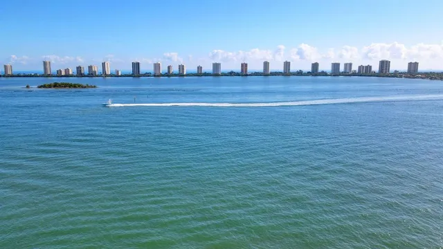 a view of a large body of water with a house in the background