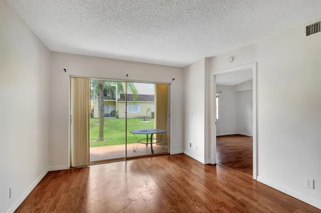 a view of an empty room with glass door