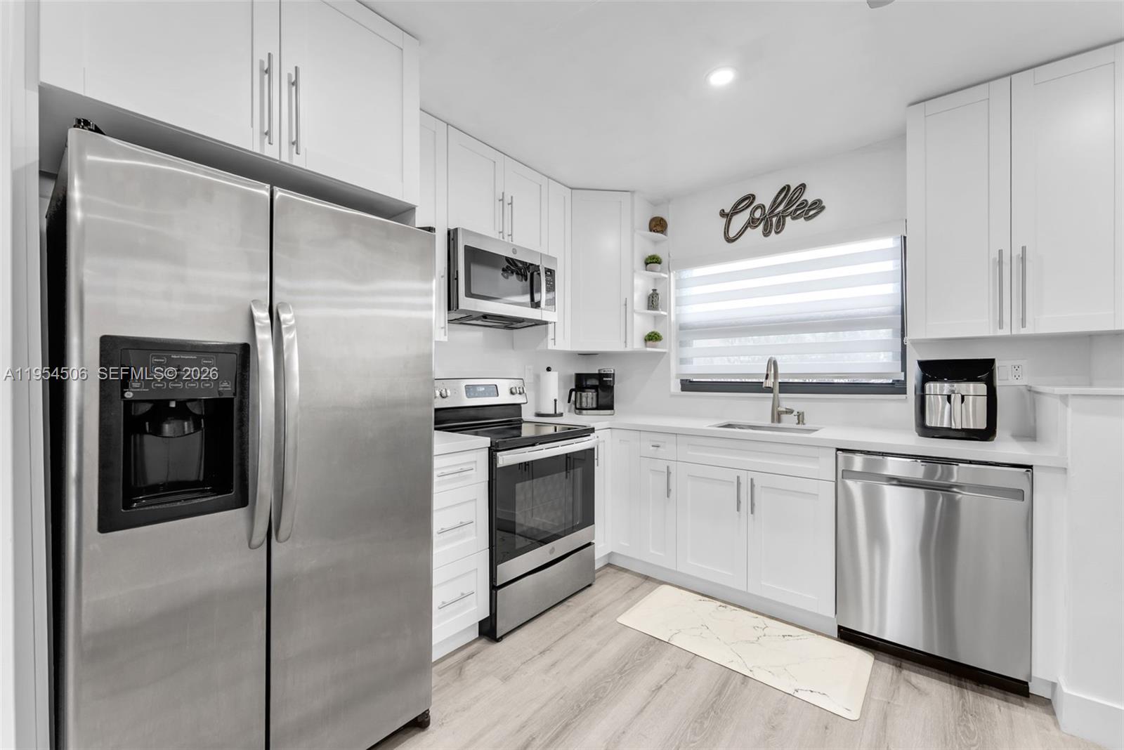 12234 Southwest 114th Terrace Miami, FL 33186 - Photo 12 of 22 a kitchen with cabinets stainless steel appliances and a window
