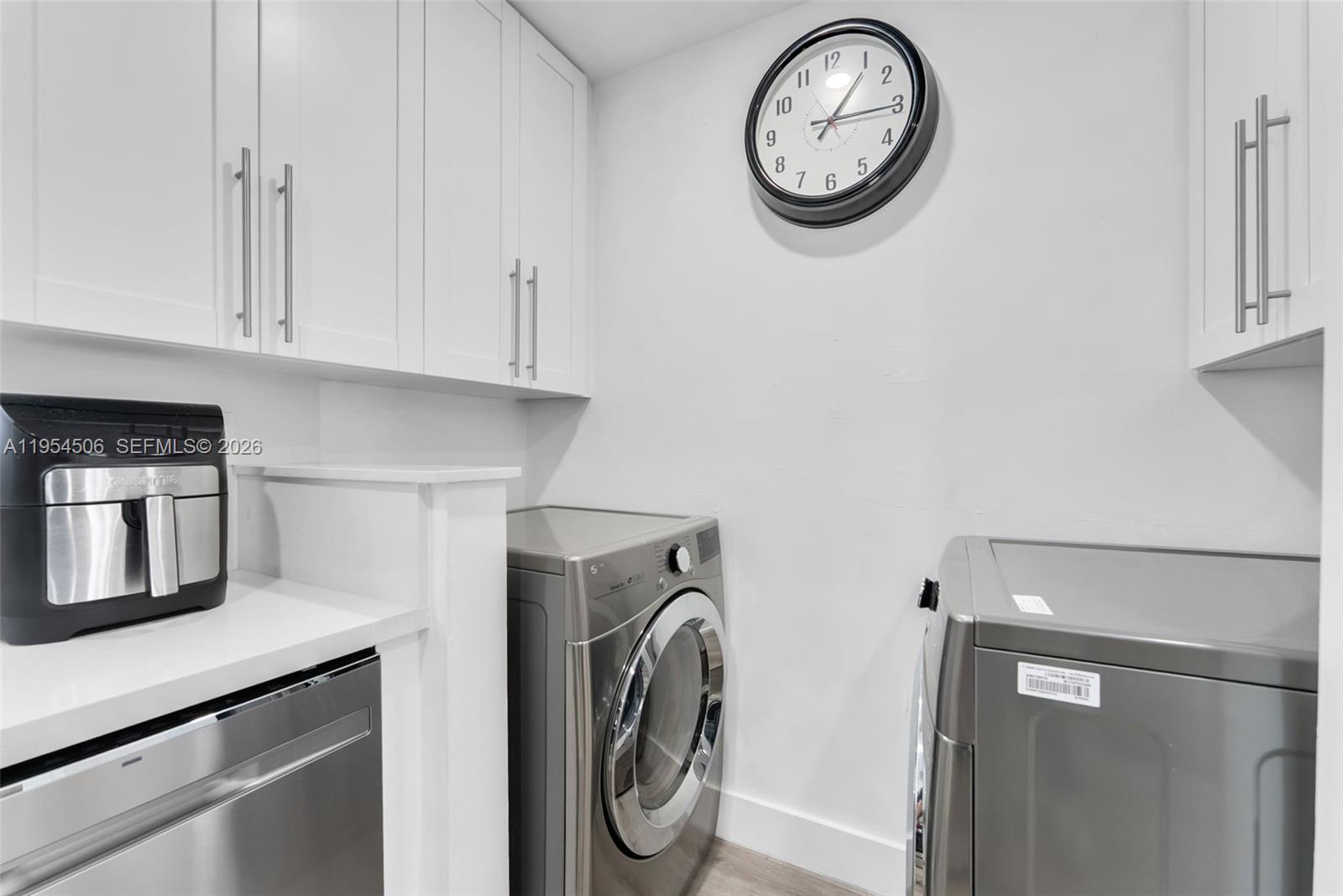 12234 Southwest 114th Terrace Miami, FL 33186 - Photo 13 of 22 a view of storage and utility room with washer and dryer
