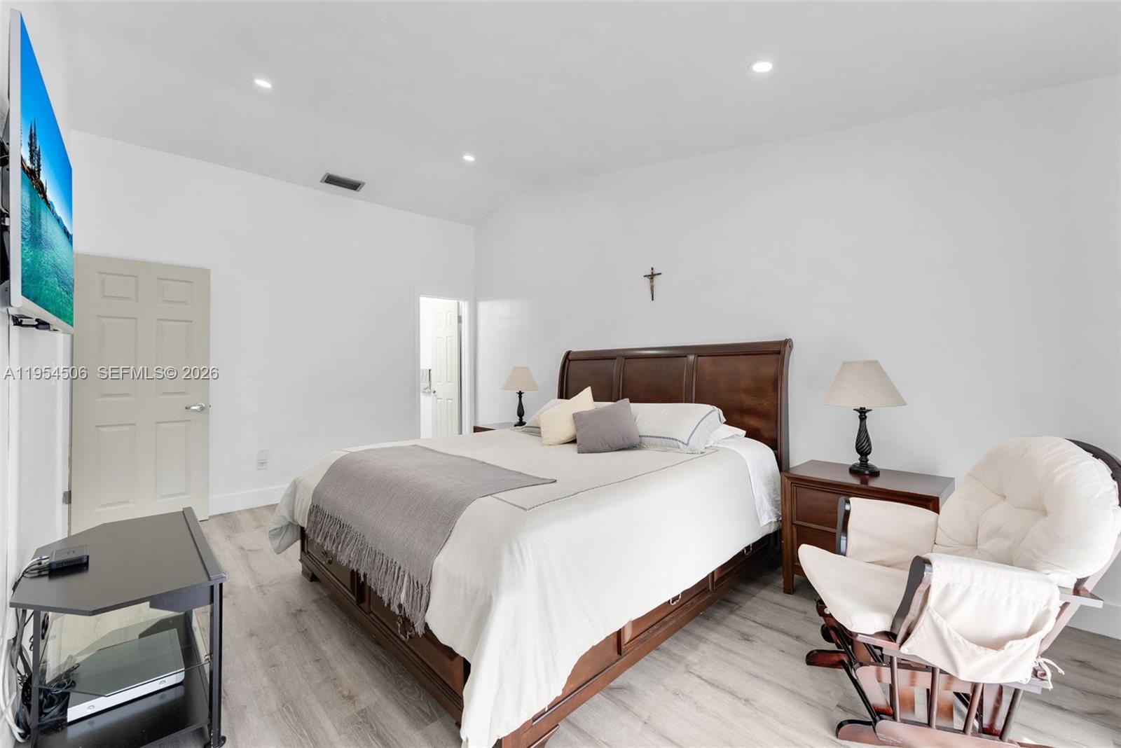 12234 Southwest 114th Terrace Miami, FL 33186 - Photo 17 of 22 a bedroom with a bed and chair