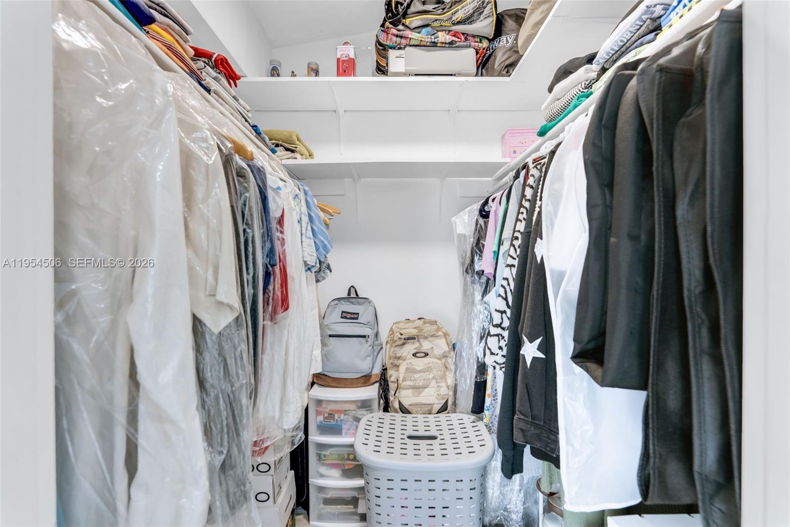 12234 Southwest 114th Terrace Miami, FL 33186 - Photo 18 of 22 a view of walk in closet with clothes and shoes