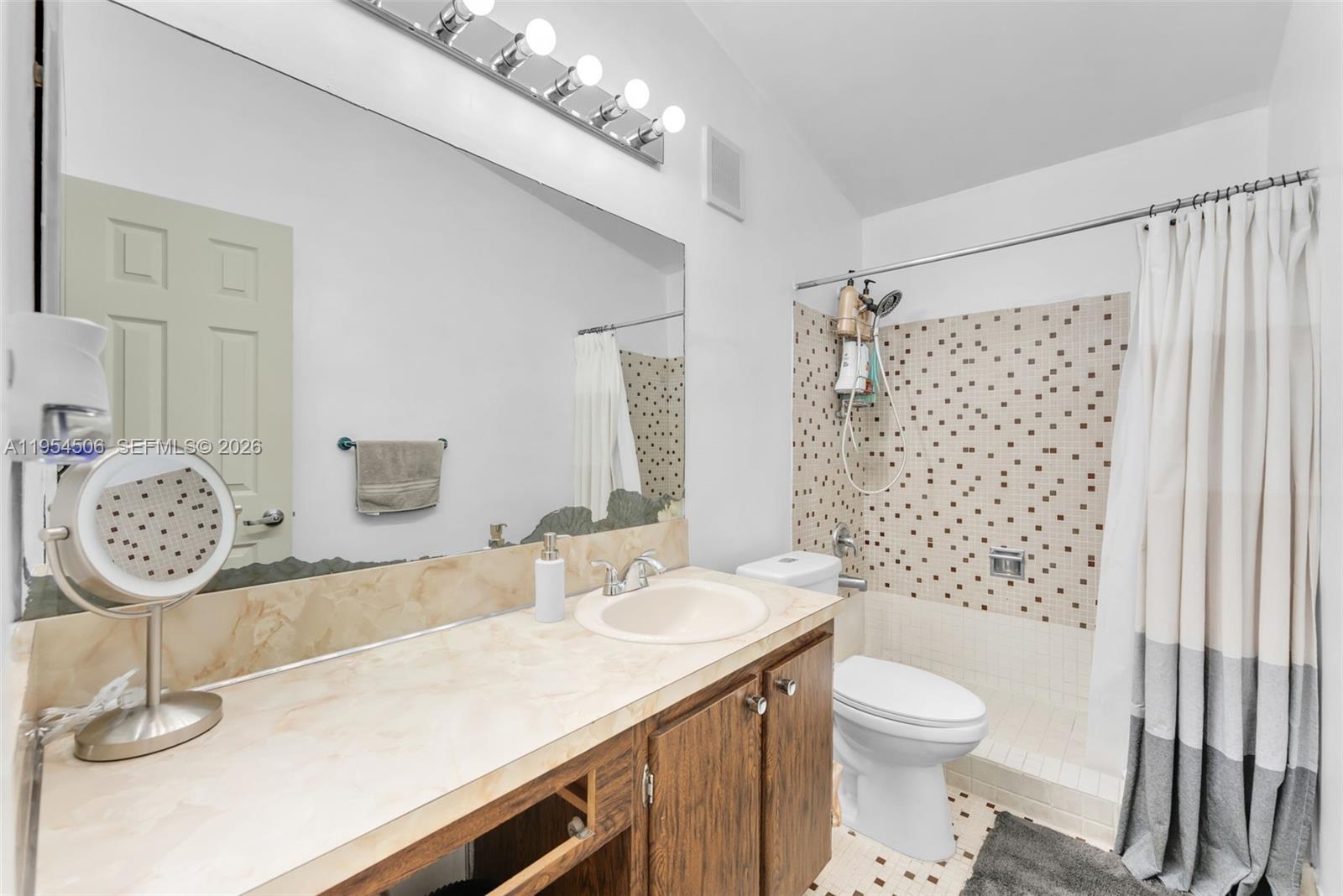 12234 Southwest 114th Terrace Miami, FL 33186 - Photo 20 of 22 a bathroom with a sink a toilet and shower