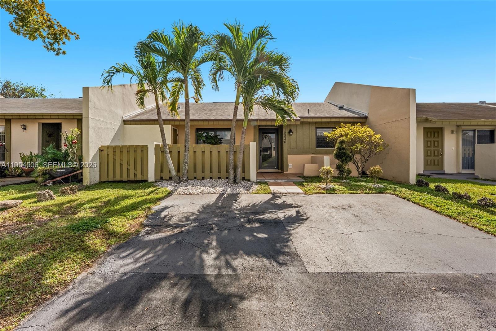 12234 Southwest 114th Terrace Miami, FL 33186 - Photo 2 of 22 a front view of a house with a yard