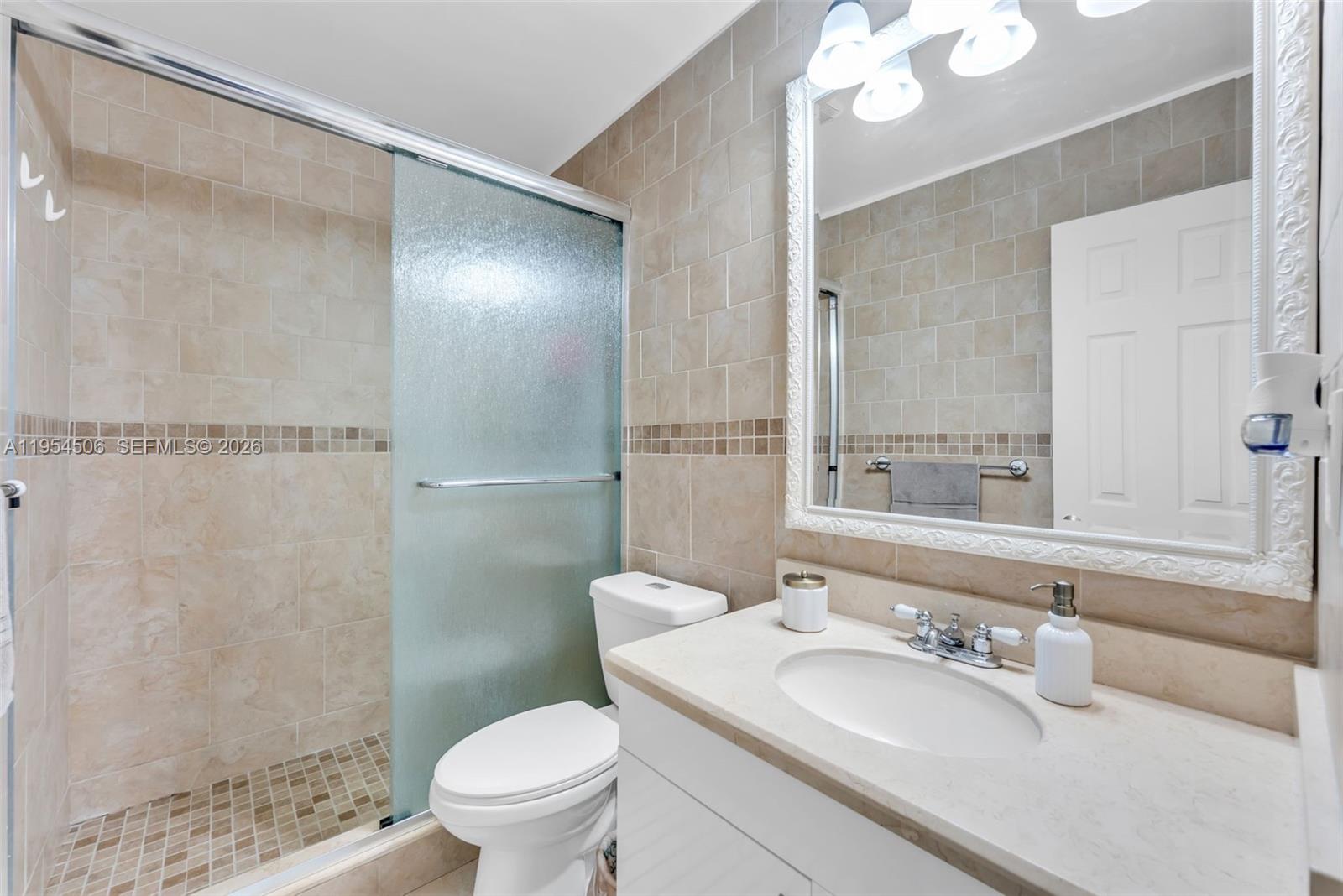 12234 Southwest 114th Terrace Miami, FL 33186 - Photo 21 of 22 a bathroom with a sink a toilet and shower