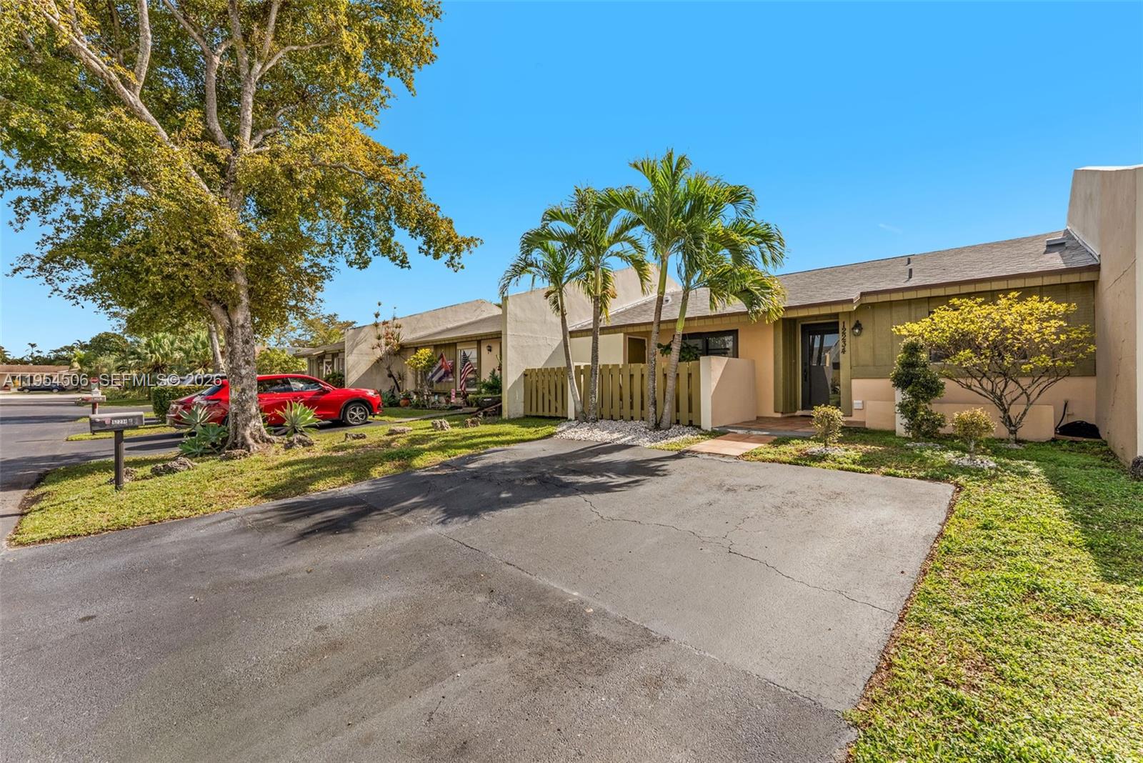 12234 Southwest 114th Terrace Miami, FL 33186 - Photo 4 of 22 a front view of a house with a yard and garage