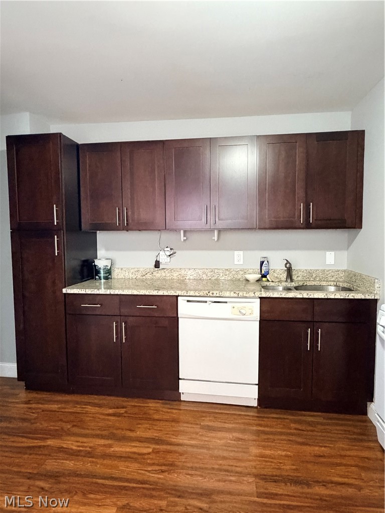 2017 Random Road Cleveland, OH 44106 - Photo 8 of 20 Wood-finish flooring, dark wood cabinetry, light-colored stone-look countertops, and a white dishwasher