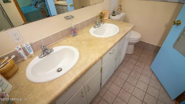 a bathroom with a sink vanity and a mirror