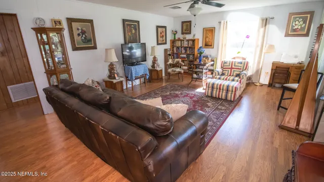 a living room with furniture and wooden floor