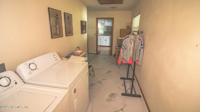 a kitchen with stainless steel appliances a stove a sink a refrigerator wooden floor a dining table and chairs