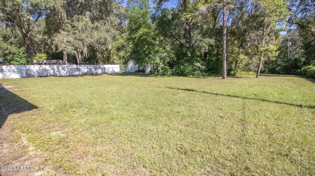 a view of a yard with an trees