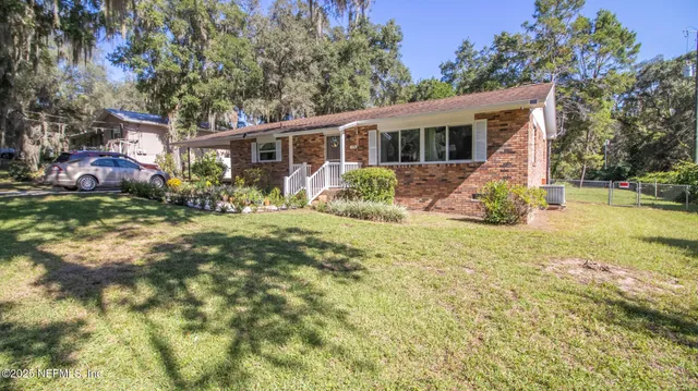 a front view of a house with a yard table and chairs