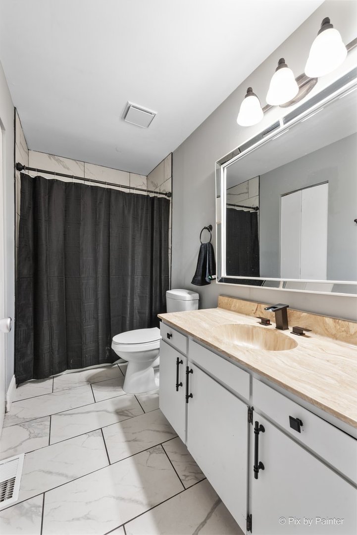 1104 Florimond Drive, Unit 1104 Elgin, IL 60123 - Photo 16 of 28 a spacious bathroom with a granite countertop sink and a mirror