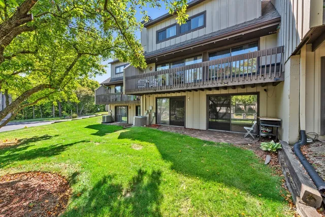a view of a house with a yard and sitting area