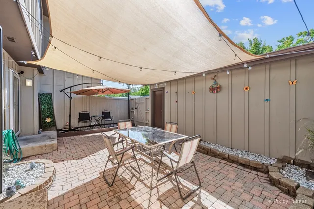 a view of a patio with table and chairs