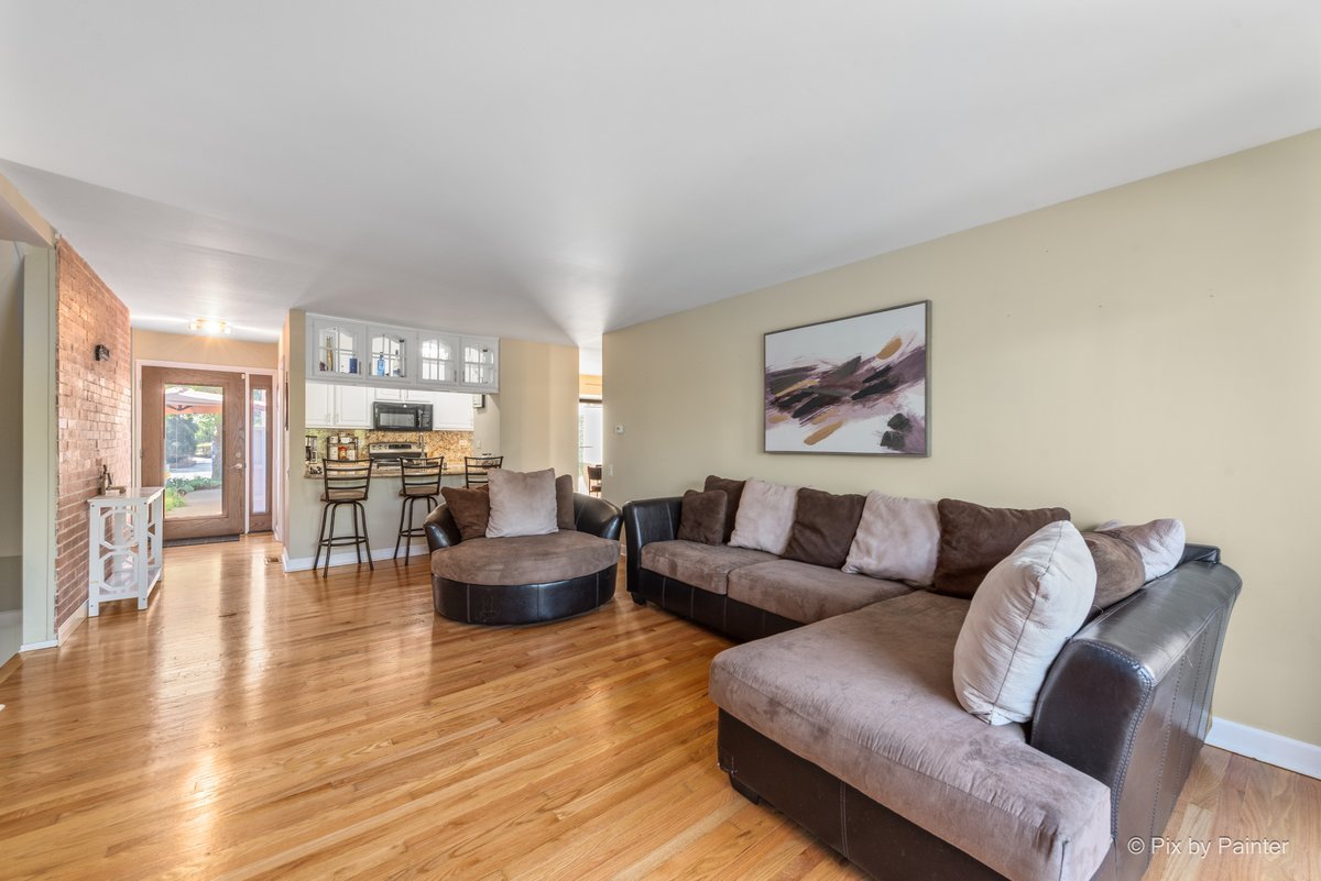 1104 Florimond Drive, Unit 1104 Elgin, IL 60123 - Photo 6 of 28 a living room with furniture or couch and a wooden floor