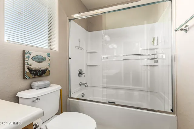 a bathroom with a shower a toilet and a shower