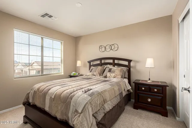 a bedroom with a bed and a window