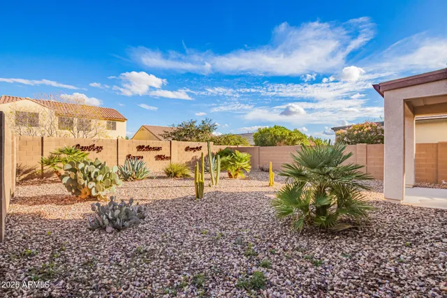 a view of a yard with wooden fence