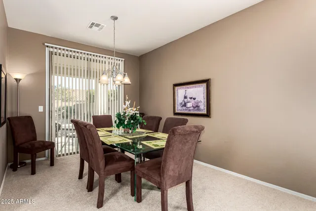 a view of a dining room with furniture and window