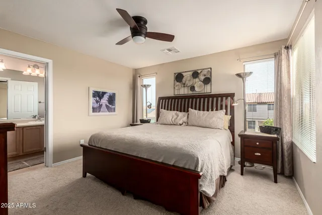 a bedroom with a bed and a painting on the wall