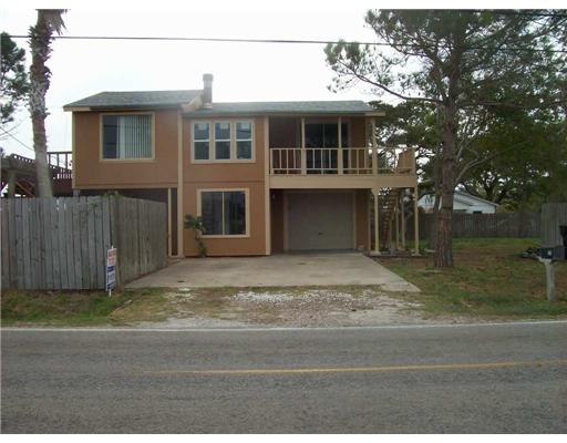a house that has a tree in front of it