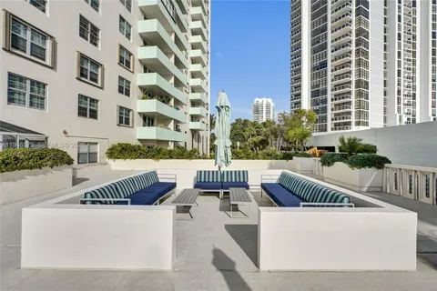 a view of a patio with couches and potted plants