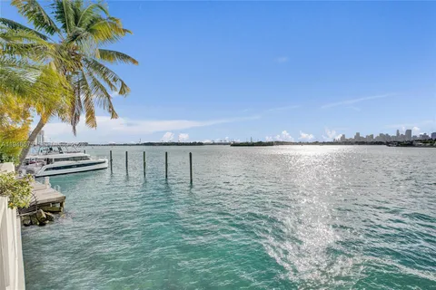 a view of a lake with houses in the back