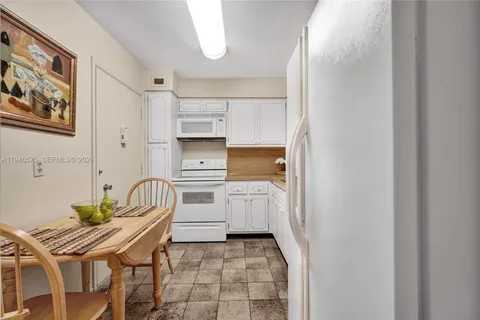a kitchen with a sink appliances and cabinets