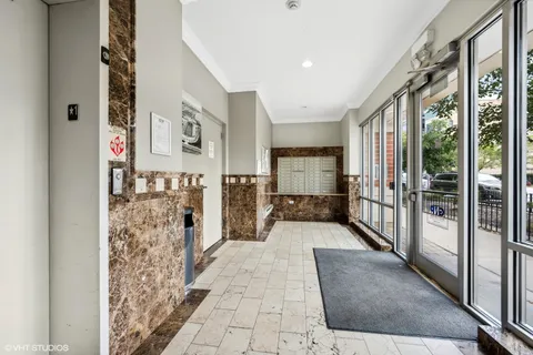 a lobby with furniture and large windows