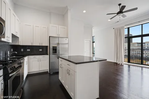 a kitchen with stainless steel appliances granite countertop a stove and a refrigerator