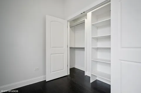 a view of walk in closet with empty racks