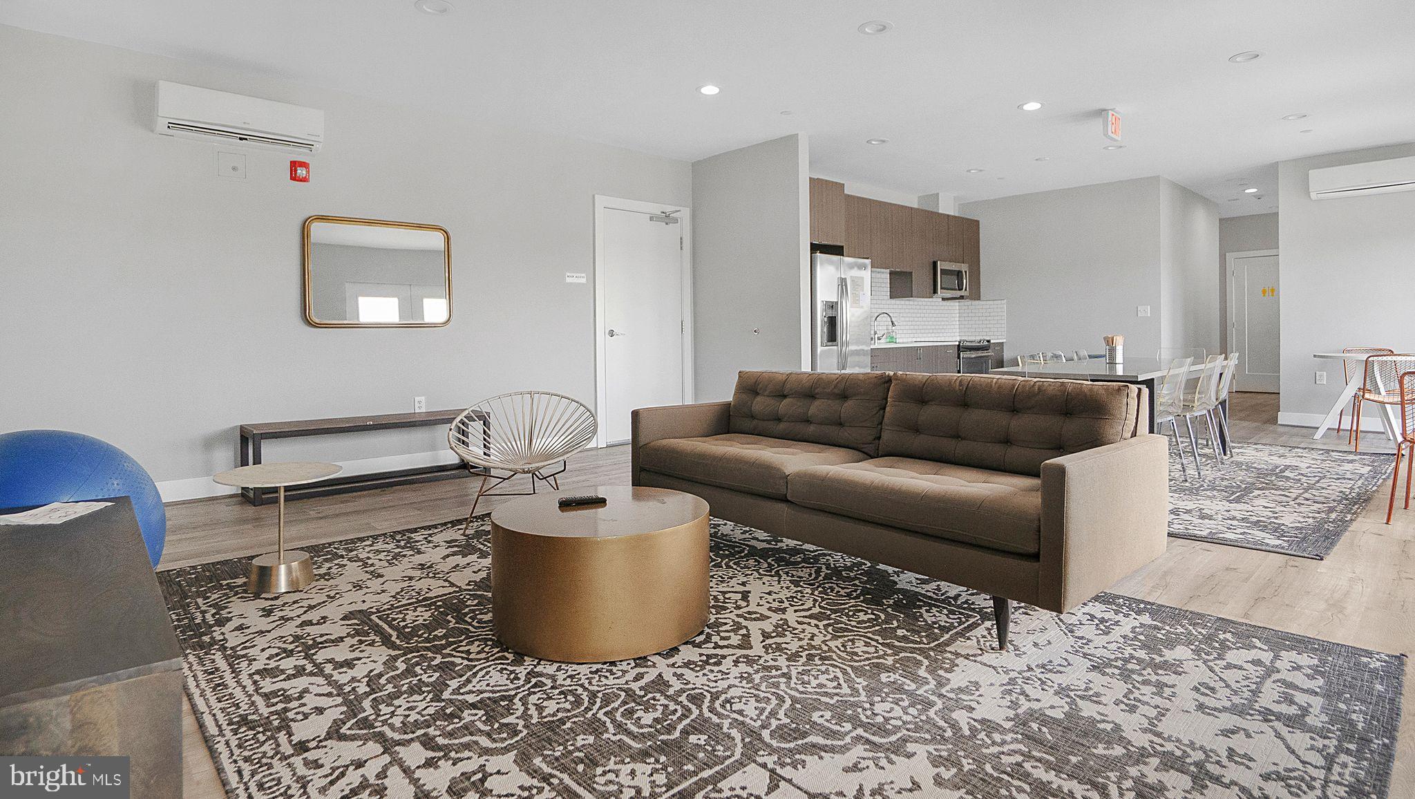 1111 Orren Street Northeast, Unit 407 Washington, DC 20002 - Photo 13 of 16 a living room with furniture and a couch