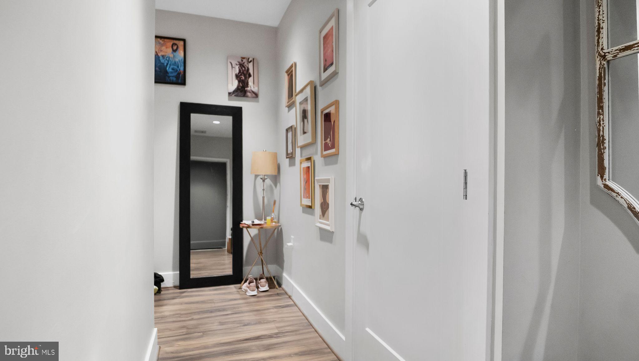1111 Orren Street Northeast, Unit 407 Washington, DC 20002 - Photo 8 of 16 a view of a hallway with wooden floor and entryway