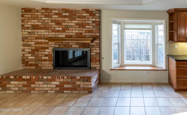 a kitchen with granite countertop a stove top oven microwave and cabinets