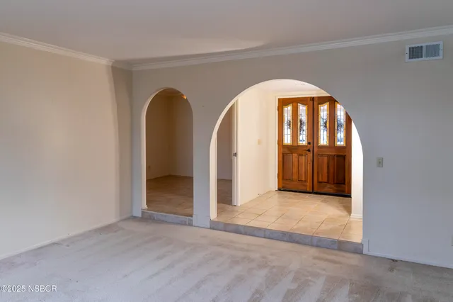 an empty room with fan and windows